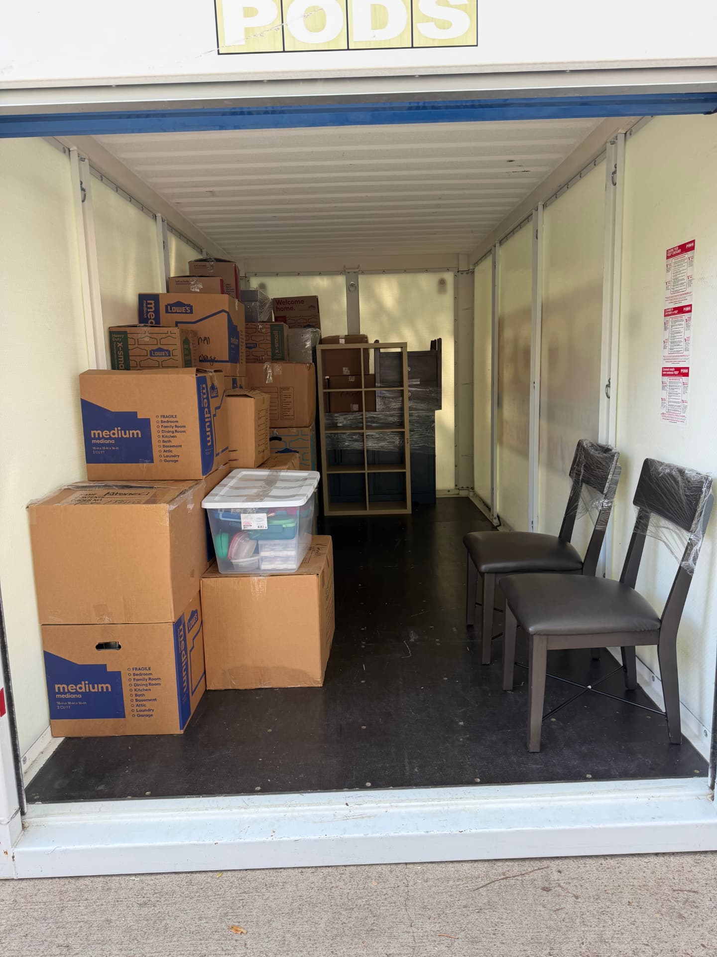 Moving container packed with boxes and furniture