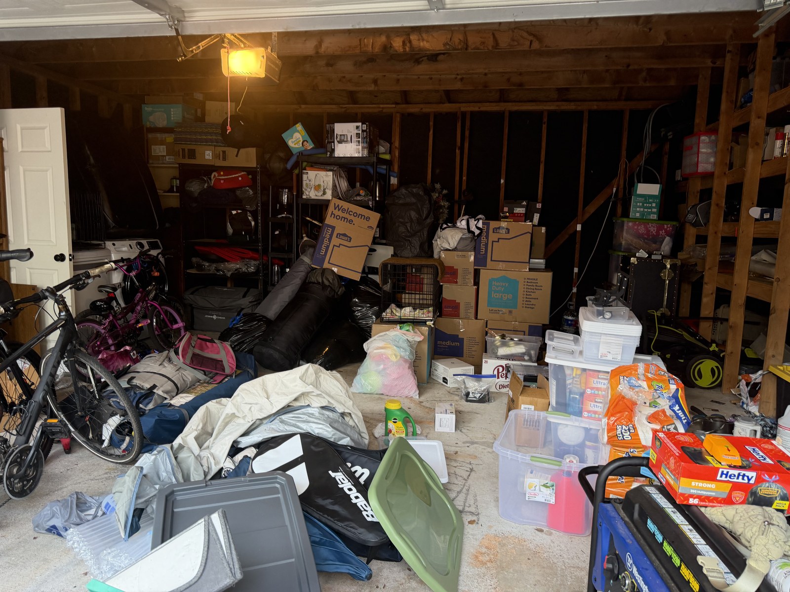 Garage with bins, equipment and moving boxes