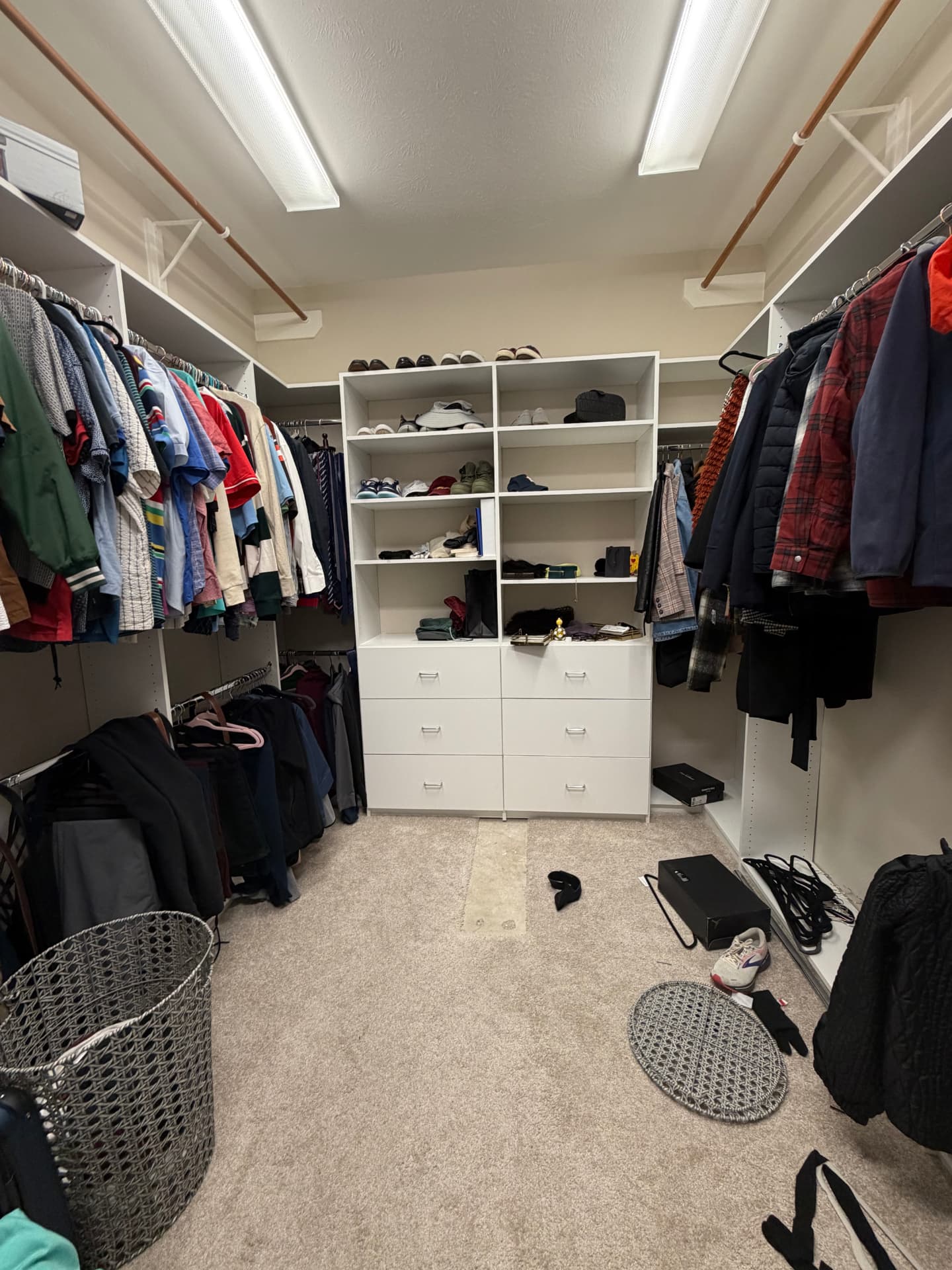 Walk-in closet before organizing with shelves half empty